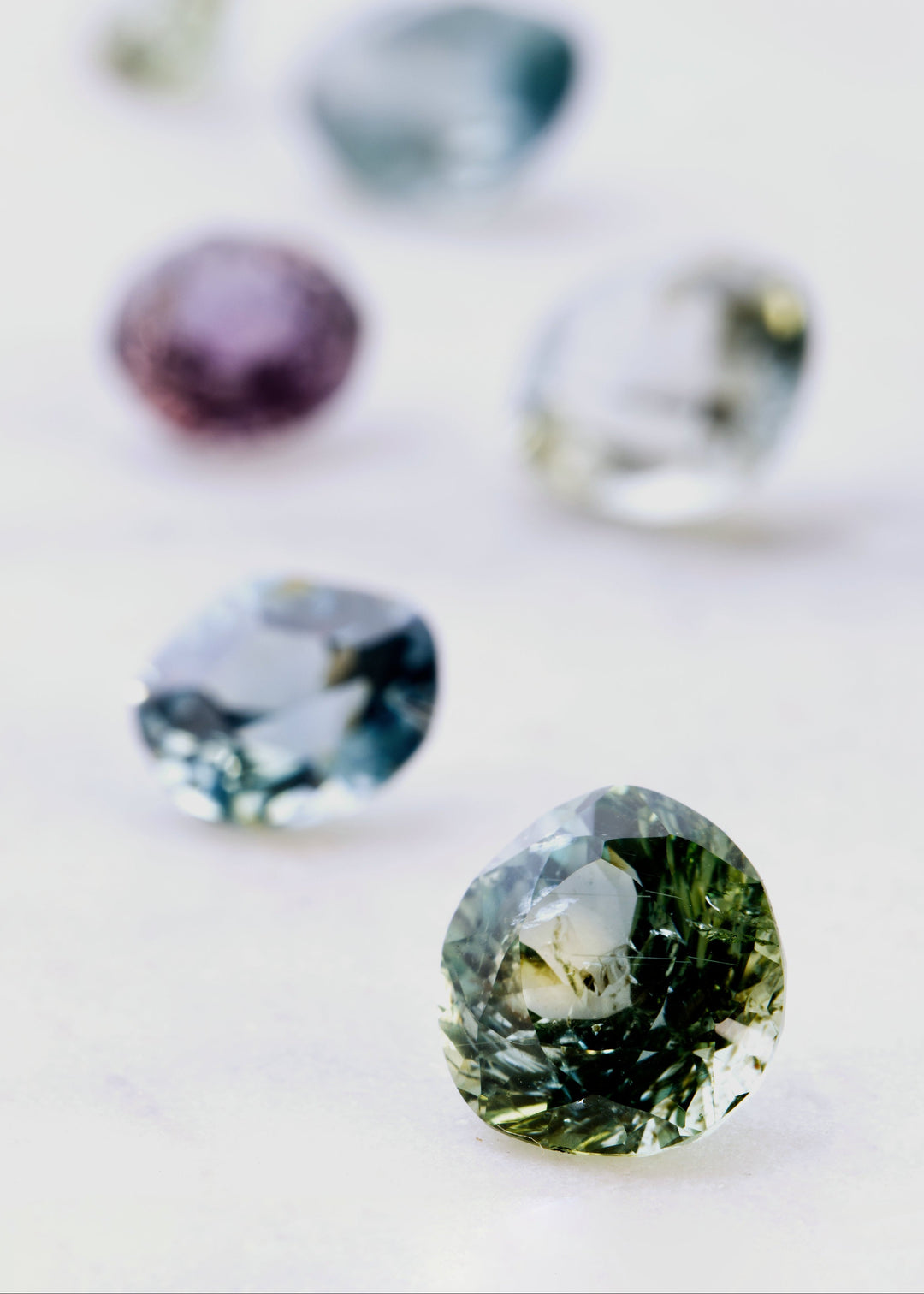 Close-up of two green gemstones on a light background