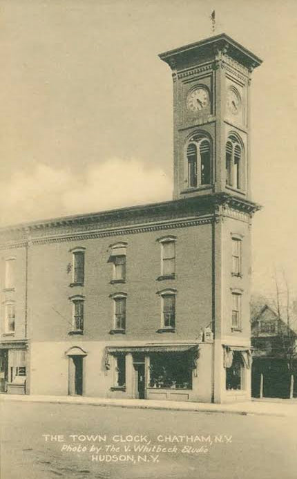 Vintage postcard-style photograph of a town clock building in Chatham, N.Y.