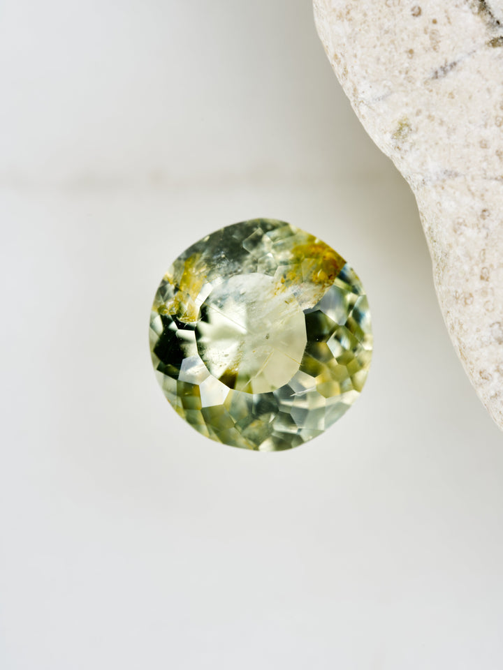Lichen Glow — 1.550ct yellow round Montana sapphire, 7mm, unheated